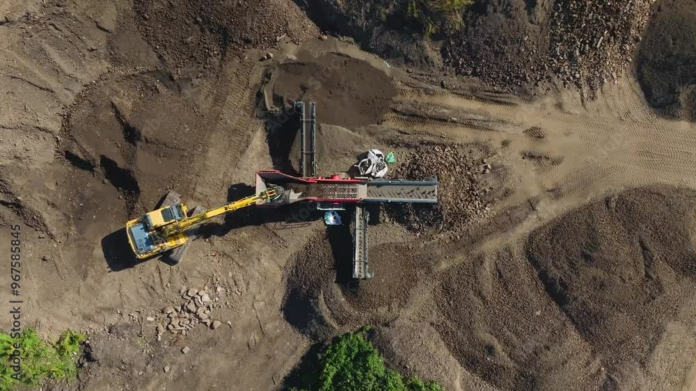 Aerial view of composting site with excavator and industrial machinery, East Linton, Scotland. Aerial view of composting site with excavator and industrial machinery, East Linton, Scotland.