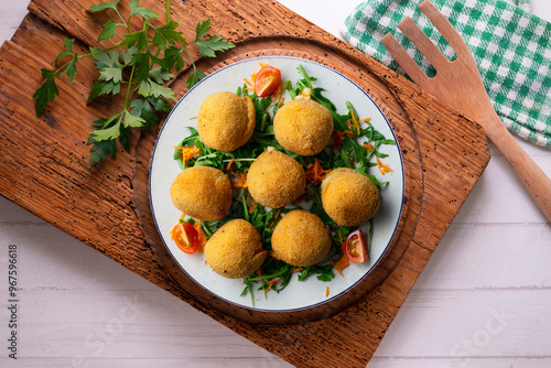 Spanish Tapa croquettes made with bechamel sauce and stuffed with iberian ham. Top view table with christmas decoration. photo