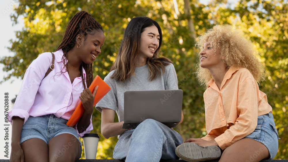 Low angle view of happy students discussing after Low angle view of happy students discussing in a park after university class outdoors. Low angle view of happy students discussing after Low angle view of happy students discussing in a park after university class outdoors.