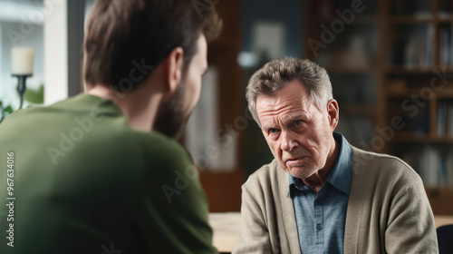 Alzheimer Older man looking at his son with unrecognized and absentminded