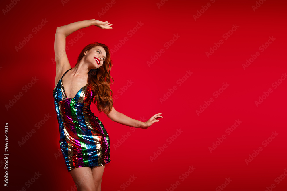 Naklejka premium Portrait of stunning young girl dance look empty space ad glossy dress isolated on vibrant red color background