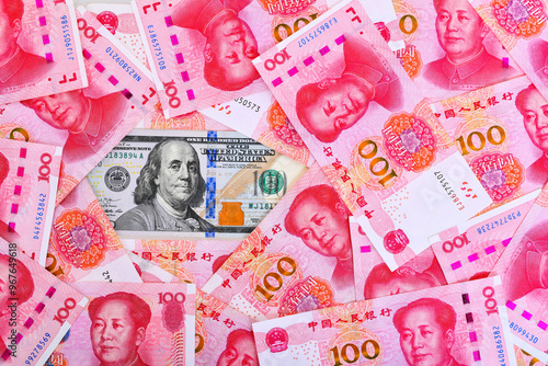 100US dollar and 100 Chinese yuan renminbi banknotes background. 