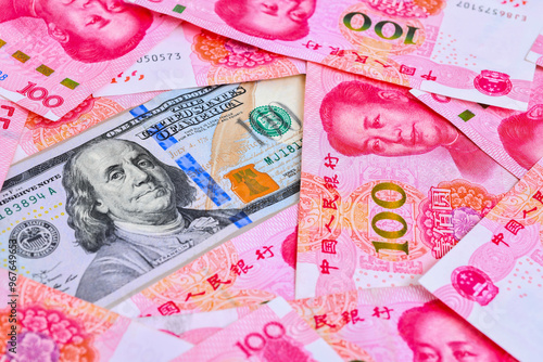 100US dollar and 100 Chinese yuan renminbi banknotes background. 