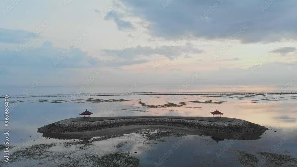 Aerial view of serene beach at sunrise with reflection on the Indian Ocean, Pantai Sanur, Bali, Indonesia. Aerial view of serene beach at sunrise with reflection on the Indian Ocean, Pantai Sanur, Bali, Indonesia.
