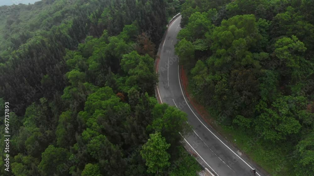 Aerial view of the scenic curve of the famous Hai Van Pass road surrounded by lush greenery and mountains, Da Nang, Vietnam. Aerial view of the scenic curve of the famous Hai Van Pass road surrounded by lush greenery and mountains, Da Nang, Vietnam.
