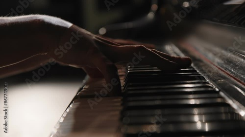 The hands of a woman playing the piano