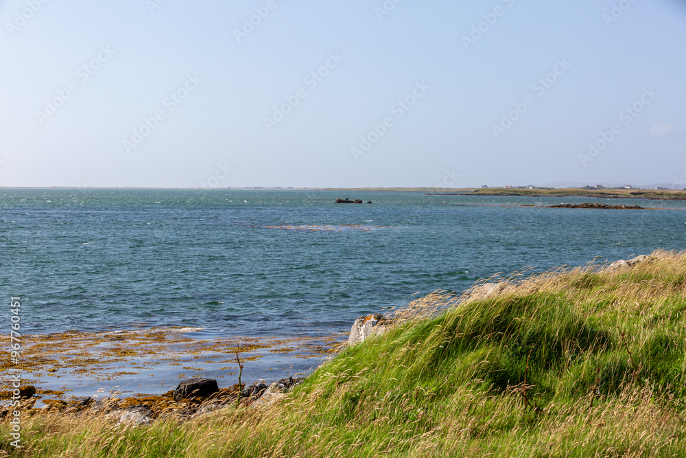 Landscape view of North Uist, Image shows a beautiful scenic photo of the remote Scottish island coastline during the summer Landscape view of North Uist, Image shows a beautiful scenic photo of the remote Scottish island coastline during the summer