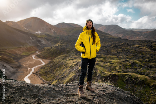 Adventurous Hiker in Yellow Jacket Exploring Mountain Landscape