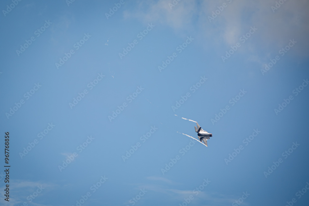 F35 Lightning flying over RAF Lakenheath during sunset creating wingtip vortex's, from a public road F35 Lightning flying over RAF Lakenheath during sunset creating wingtip vortex's, from a public road