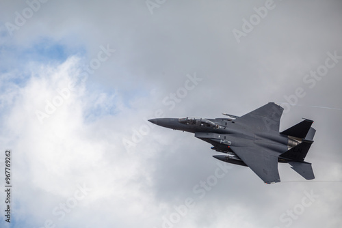 F15 fighter jet taking off with landing gear up, from a public road