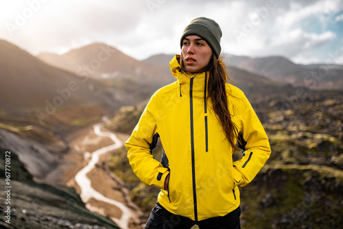 Adventurous Hiker in Yellow Jacket Exploring Mountain Landscape