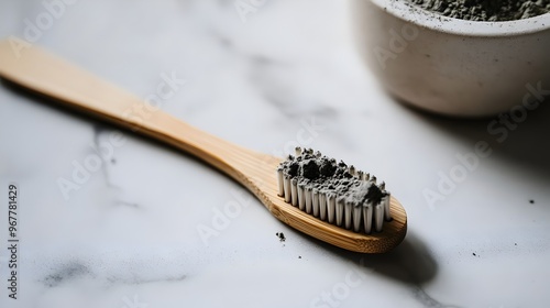 Close up photography of a natural wood and real bristle toothbrush using fluoride free tooth powder photo