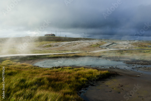 Geothermal Hot Springs in Lush Green Icelandic Landscape with Rising Steam
