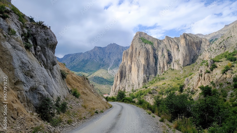 Rugged mountain road with sharp turns and dramatic cliffs Rugged mountain road with sharp turns and dramatic cliffs
