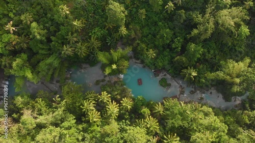 Aerial view of a serene waterfall and stream surrounded by lush tropical forest, Cambugahay Falls, Siquijor, Philippines. photo