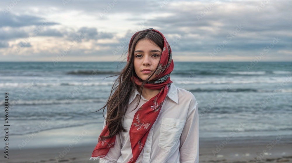 A beautiful girl is standing on the beach wearing a Ukrainian-style headscarf. A beautiful girl is standing on the beach wearing a Ukrainian-style headscarf.