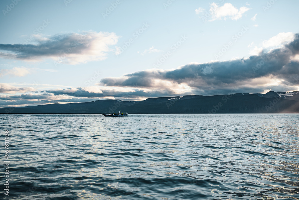 Sunlight Piercing Through Clouds Over Mountain Lake at Dusk Sunlight Piercing Through Clouds Over Mountain Lake at Dusk