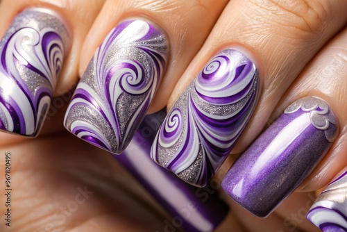 Glossy, smooth, and curved, a close-up of a squoval-shaped nail art design features intricate, swirling patterns in photo