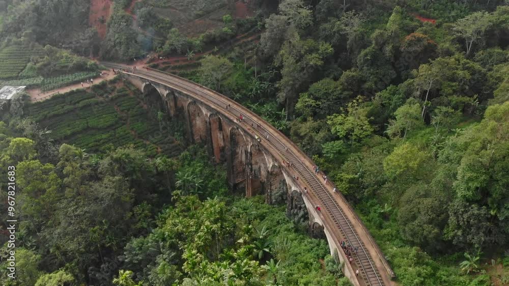 Aerial view of the iconic nine arches bridge surrounded by lush tea fields and forest, Ella, Sri Lanka. Aerial view of the iconic nine arches bridge surrounded by lush tea fields and forest, Ella, Sri Lanka.