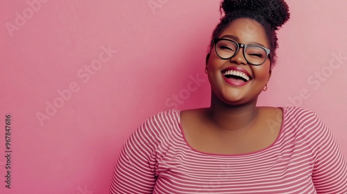 Happy body positive woman in glasses smiling against a pink background with ample copy space.