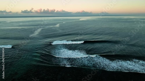 Aerial view of serene ocean waves and vibrant reef under a tranquil sunset, Tuamasaga, Samoa. photo