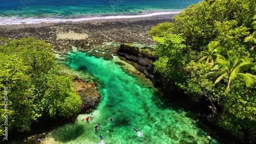 Aerial view of idyllic tropical island with turquoise ocean and coral reef, Atua, Samoa. photo