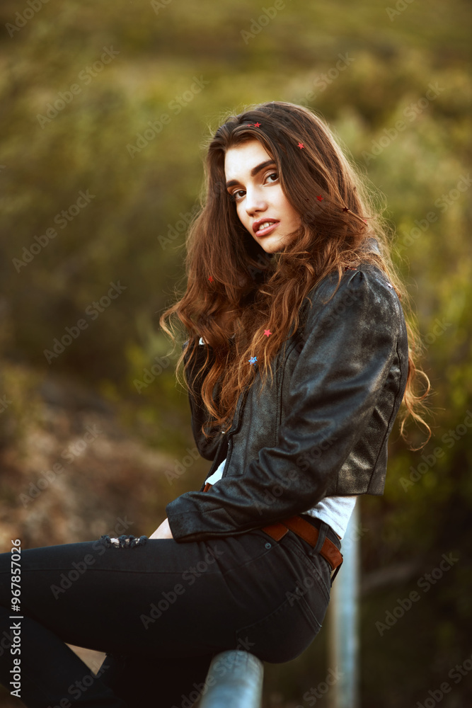 Woman, portrait and nature with fashion for style, weekend or outdoor holiday on pole. Young, female person or attractive brunette with stylish clothing, hairstyle or glitter in cool outfit or jacket Woman, portrait and nature with fashion for style, weekend or outdoor holiday on pole. Young, female person or attractive brunette with stylish clothing, hairstyle or glitter in cool outfit or jacket