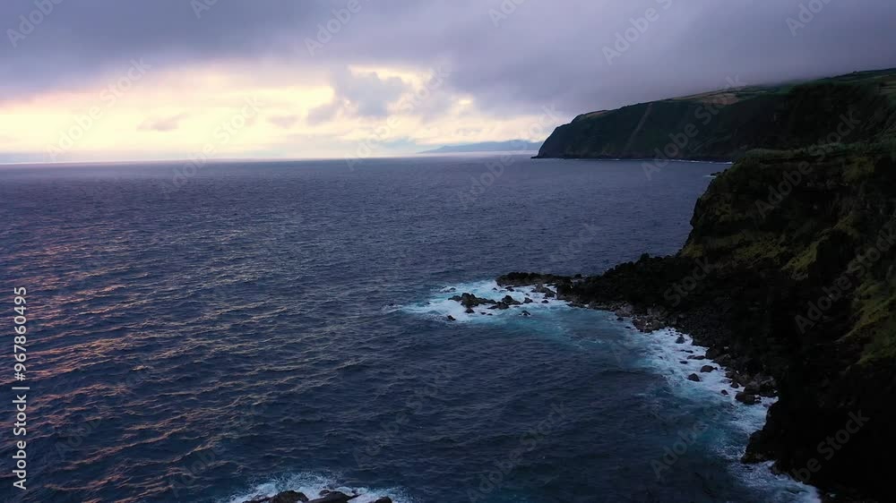 Aerial view of rugged cliffs and serene ocean waves along the coastline, Faial, Azores, Portugal. Aerial view of rugged cliffs and serene ocean waves along the coastline, Faial, Azores, Portugal.