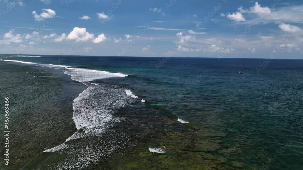 Aerial view of tropical island reef and tranquil ocean with clear blue sky and clouds, Rarotonga, Cook Islands.