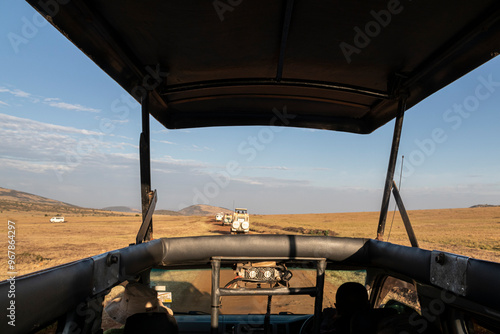 jeep trip on savanna road, safari in masai mara park, kenya, africa