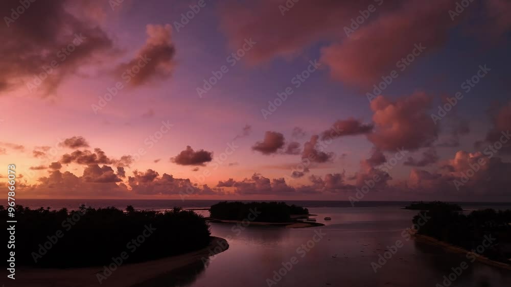 Aerial view of a tropical island with serene waters and beautiful clouds at sunrise, Rarotonga, Cook Islands. Aerial view of a tropical island with serene waters and beautiful clouds at sunrise, Rarotonga, Cook Islands.