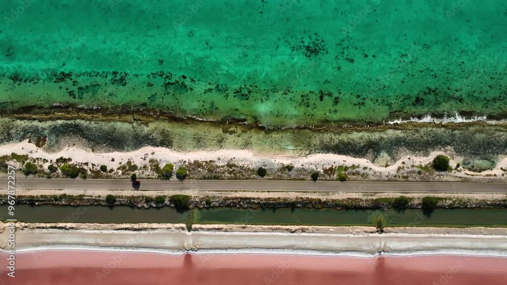 Aerial view of vibrant pink salt flats and turquoise water along the serene coastline, Caribbean. Aerial view of vibrant pink salt flats and turquoise water along the serene coastline, Caribbean.