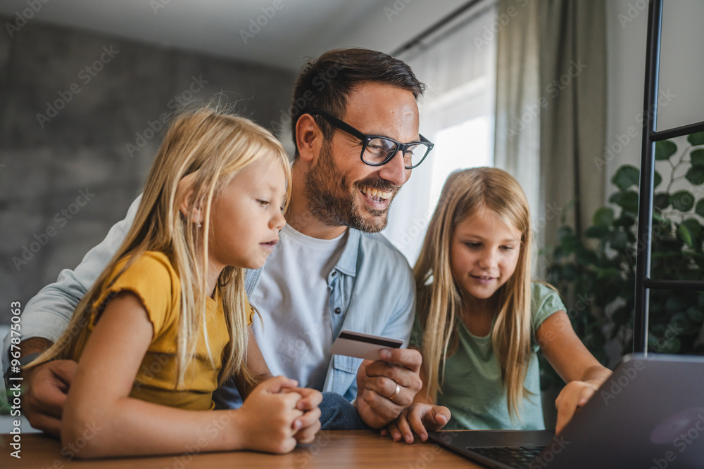 Father and daughters have online shopping on laptop with credit card Father and daughters have online shopping on laptop with credit card