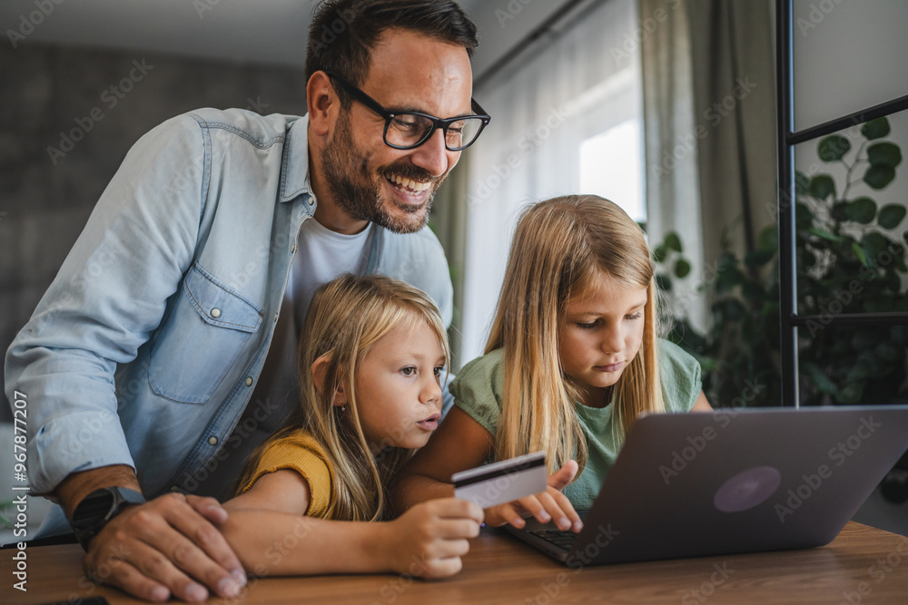Father and daughters have online shopping on laptop with credit card Father and daughters have online shopping on laptop with credit card