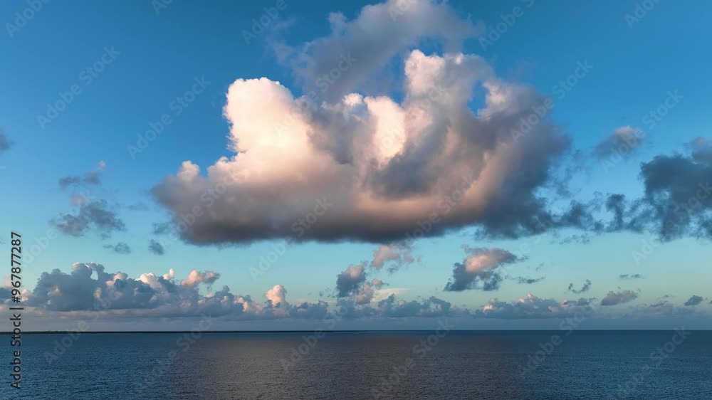 Aerial view of a tranquil tropical island surrounded by calm blue ocean and fluffy clouds, Caribbean. Aerial view of a tranquil tropical island surrounded by calm blue ocean and fluffy clouds, Caribbean.