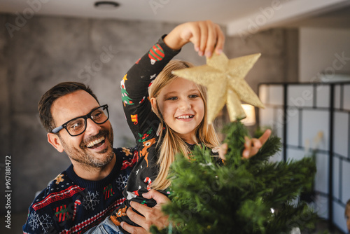 Valokuva Father and daughter decorate Christmas tree indoors together