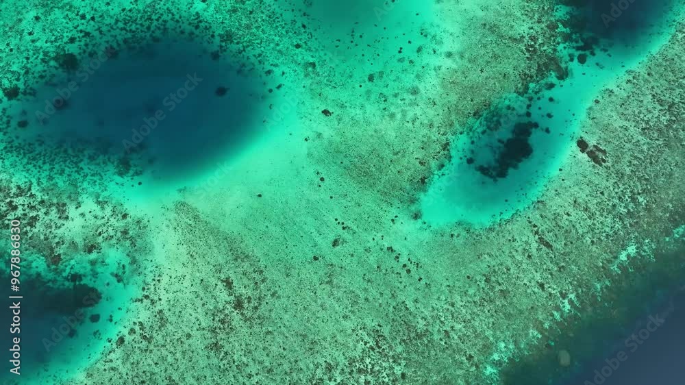 Aerial view of a beautiful blue hole and coral reef in the tranquil ocean, Western Province, Solomon Islands. Aerial view of a beautiful blue hole and coral reef in the tranquil ocean, Western Province, Solomon Islands.