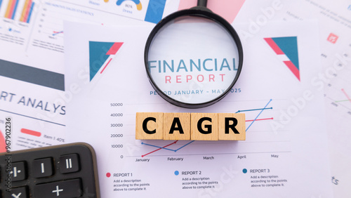 Wooden cube with the word CAGR. It is an abbreviation of Compound Annual Growth Rate. Business profitability success growth profitability analytics. Business and financial market concept. photo