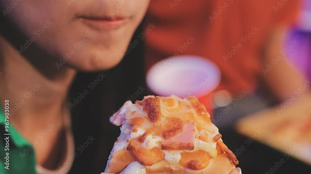 Woman eating pizza with open mouth and drink in front of her in a casual setting Woman eating pizza with open mouth and drink in front of her in a casual setting