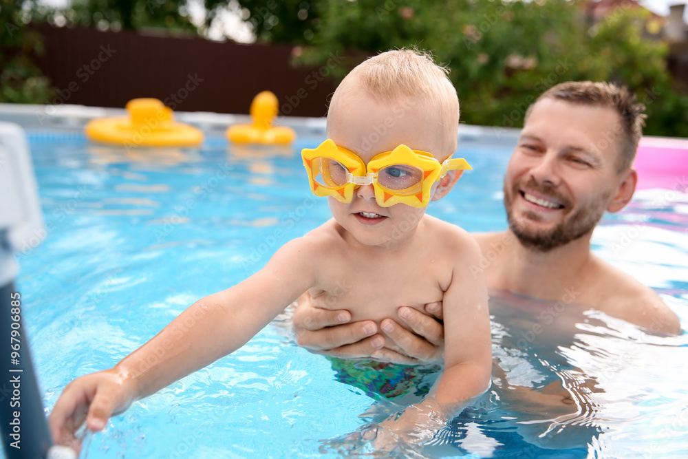 Happy father having fun with his son in swimming pool Happy father having fun with his son in swimming pool