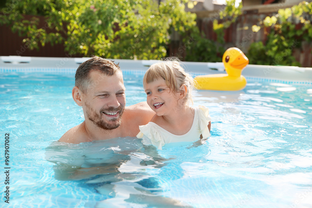 Happy father having fun with his daughter in swimming pool Happy father having fun with his daughter in swimming pool