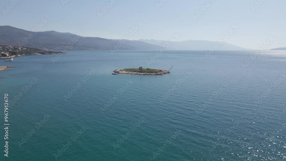 Aerial view of a serene small island surrounded by clear blue water and a scenic coastline, Novi Vinodolski, Croatia. Aerial view of a serene small island surrounded by clear blue water and a scenic coastline, Novi Vinodolski, Croatia.