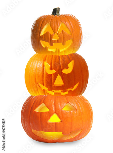 Stack of pumpkins with carved spooky faces on white background. Halloween jack-o-lanterns of different sizes photo