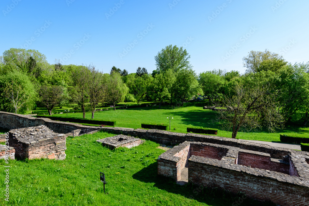 Old buildings and ruins at Targoviste Royal Court (Curtea Domneasca) in Chindia Park (Parcul Chindia) in the historical part of the city in a sunny spring day, in Romania Old buildings and ruins at Targoviste Royal Court (Curtea Domneasca) in Chindia Park (Parcul Chindia) in the historical part of the city in a sunny spring day, in Romania