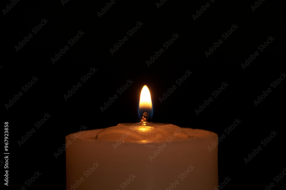 Candles burning against a black background illuminate a hope of faith Candles burning against a black background illuminate a hope of faith