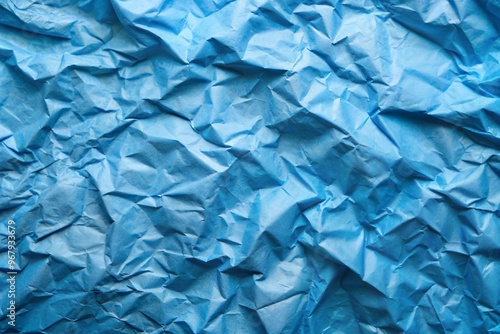 Blue crinkled tissue paper creating abstract textured background