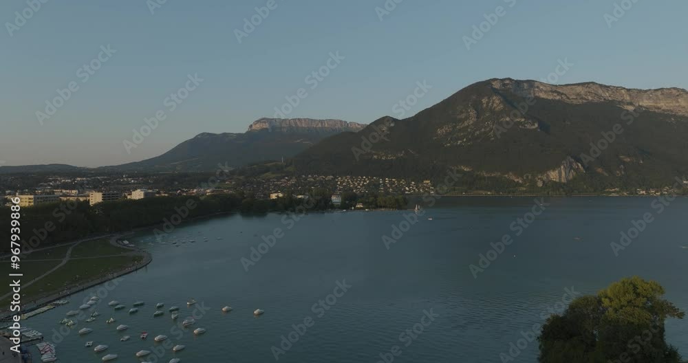 Aerial view of serene Annecy Lake surrounded by picturesque mountains and a charming town, Annecy, France. Aerial view of serene Annecy Lake surrounded by picturesque mountains and a charming town, Annecy, France.