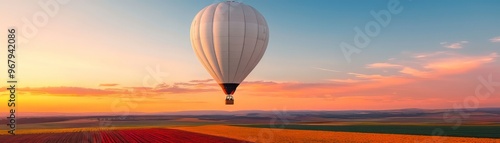 A stunning hot air balloon floats above a vibrant landscape at sunset, capturing the beauty of freedom and adventure in the sky.