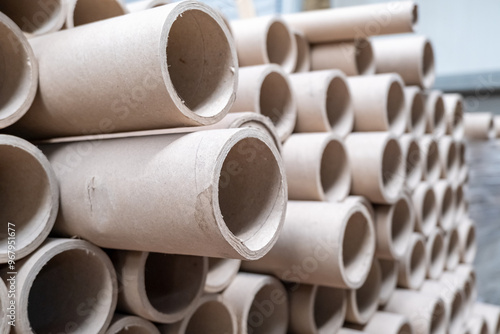 Close up view of stack of cylindrical cardboard tubes.