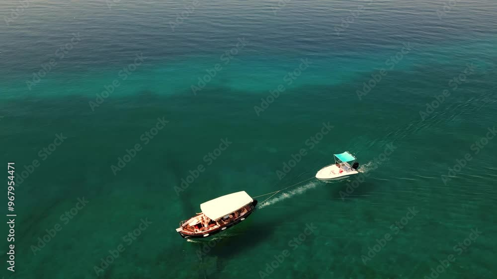 Aerial View of Little Boats Sailing on Transparent Water with Beautiful Reflections
Aerial View of Little Boats Sailing on Transparent Water with Beautiful Reflections